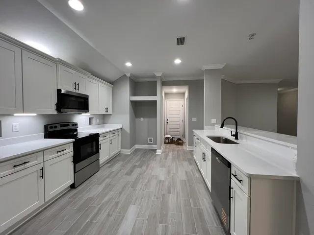 a kitchen with a sink stove and refrigerator
