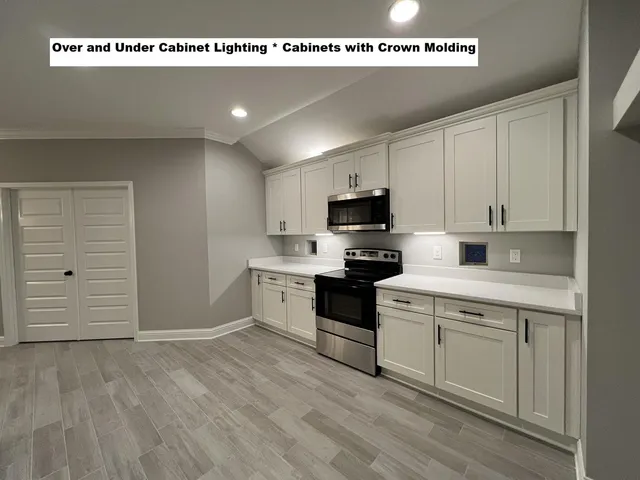 a kitchen with a stove a sink and a microwave