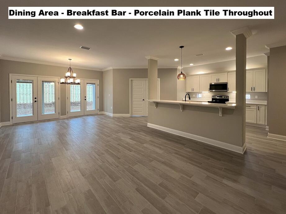 4644 Chanteuse Parkway Crestview, FL 32539 - Photo 9 of 34 a view of a kitchen with kitchen island wooden floors wooden floor and appliances
