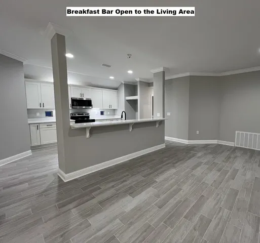 a view of kitchen with wooden floor