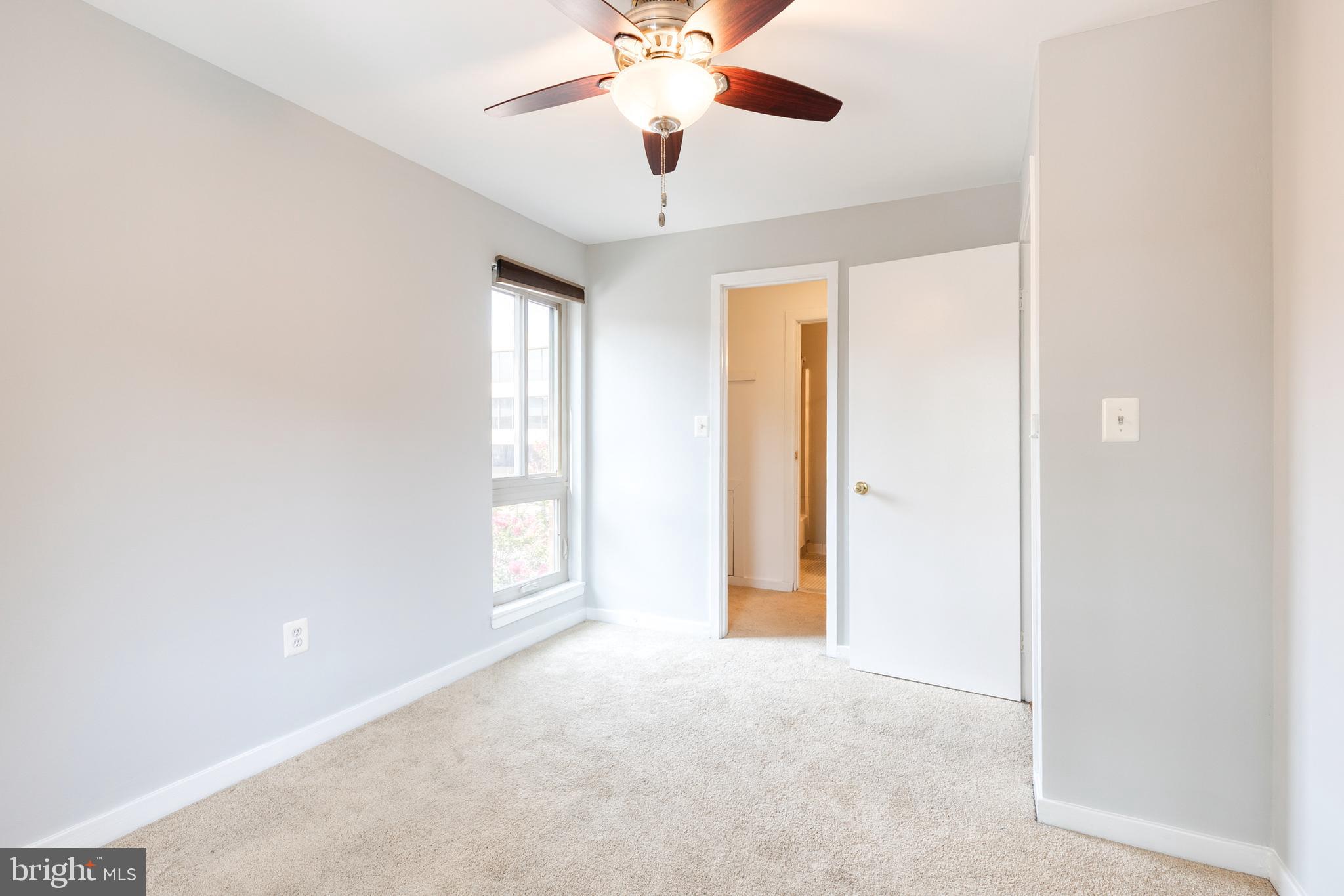 425 South Sharp Street, Unit R 15 Baltimore, MD 21201 - Photo 22 of 29 an empty room with windows and ceiling fan