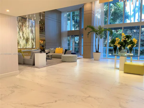 a lobby with furniture and window