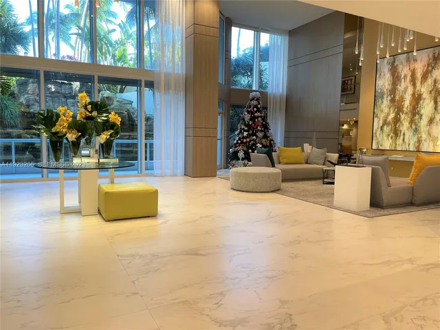 a living room filled with furniture and a potted plant