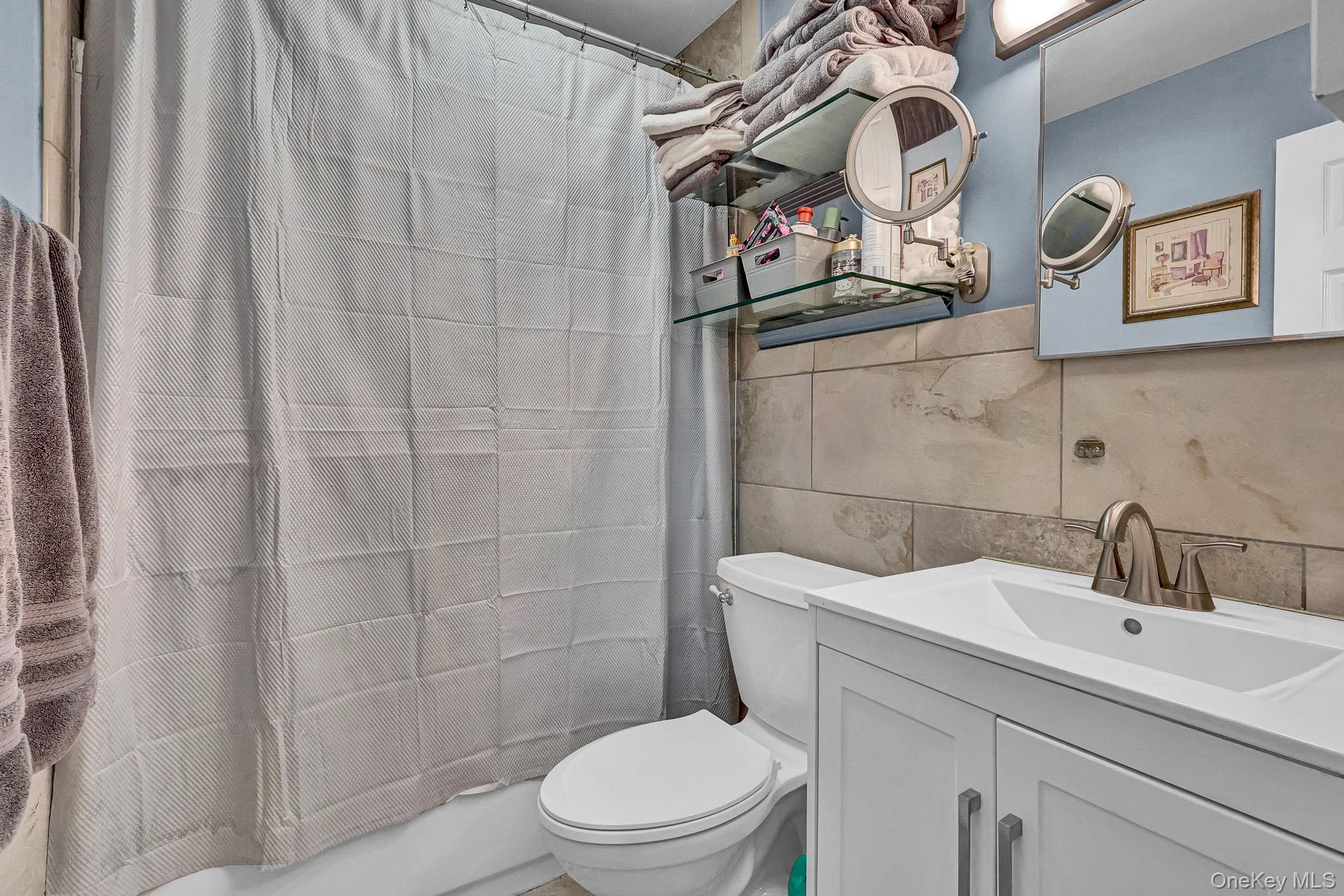 98 Granny Road Farmingville, NY 11738 - Photo 15 of 24 a bathroom with a toilet sink and vanity