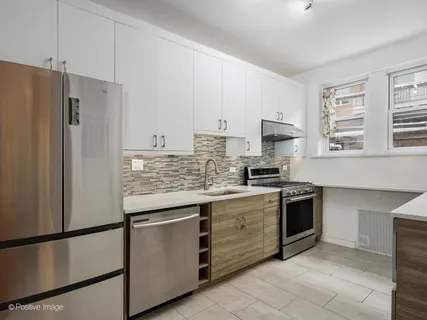a kitchen with stainless steel appliances granite countertop a stove a refrigerator and a sink