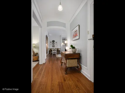 a view of living room filled with furniture and wooden floor