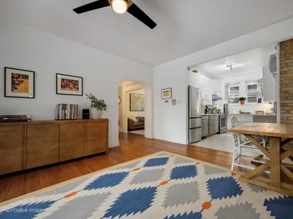 a living room with furniture and kitchen view