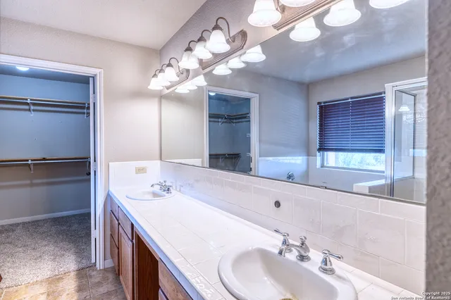 a bathroom with a sink a vanity and a mirror