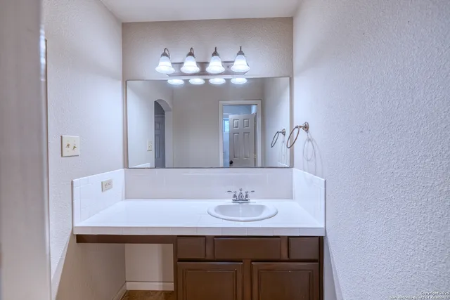 a bathroom with a sink and a mirror