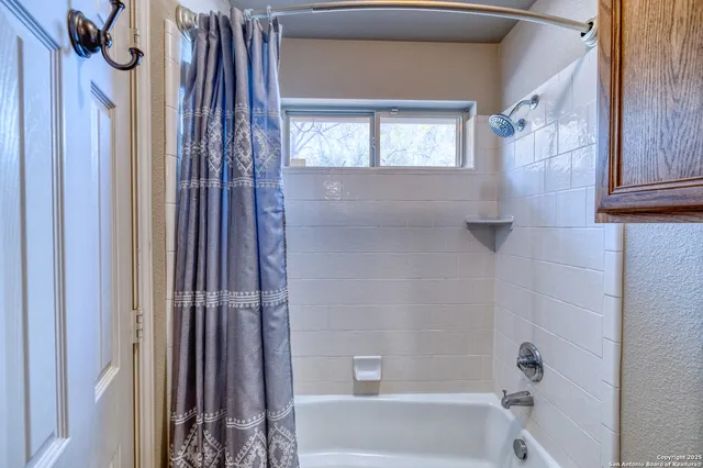 a bathroom with a shower and a tub