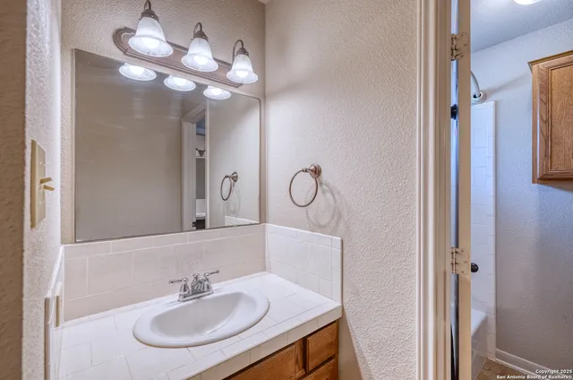 a bathroom with a sink and a mirror