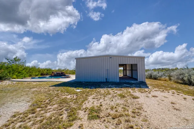 a view of a house with a yard and pathway