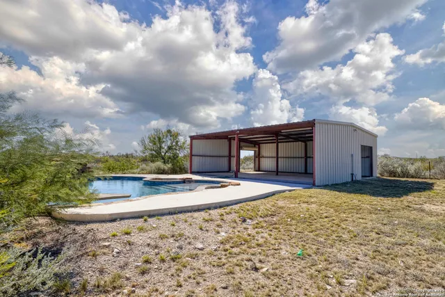 a view of swimming pool with outdoor seating