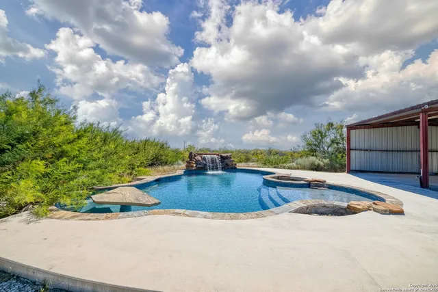 a view of a swimming pool with a yard