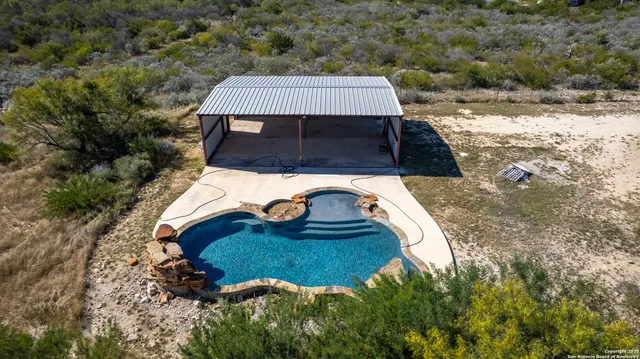 a view of a house with a yard and mountain view