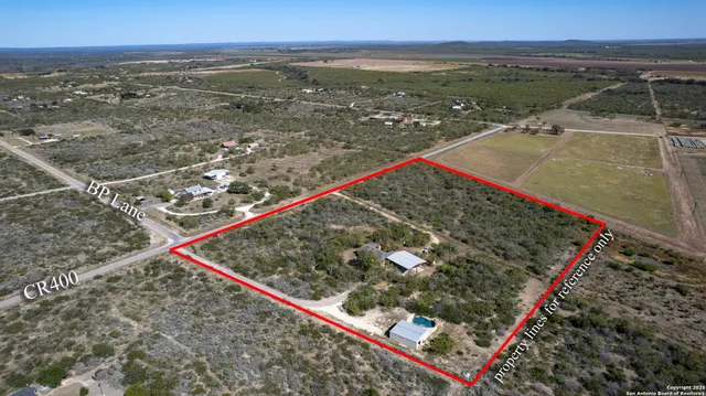 an aerial view of a house with a yard basket ball court and outdoor seating