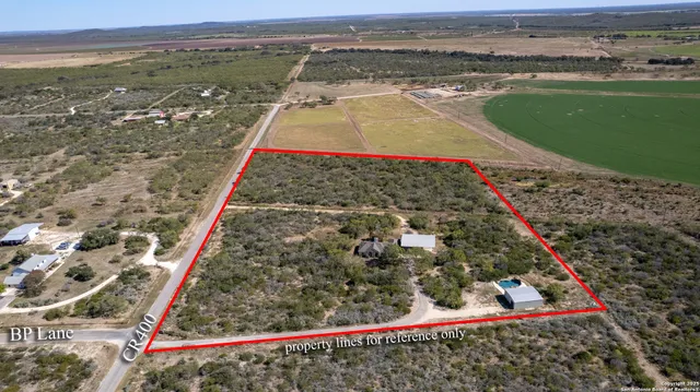 an aerial view of a house with a yard and lake view