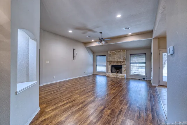 wooden floor in an empty room with a fireplace