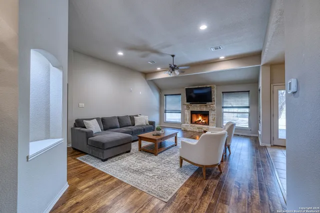a living room with furniture and a wooden floor