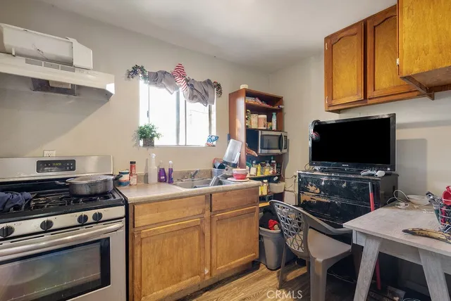 a kitchen with a stove a sink and a microwave