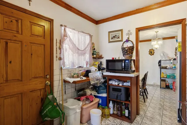 a living room with furniture a flat screen tv and a table