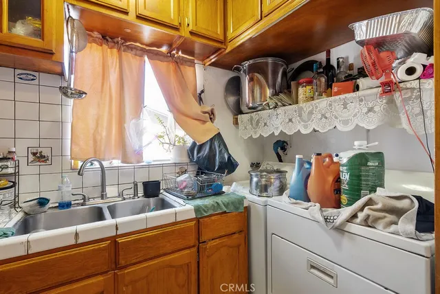 a kitchen with sink a refrigerator and window