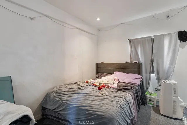 a bedroom with a bed and a mirror