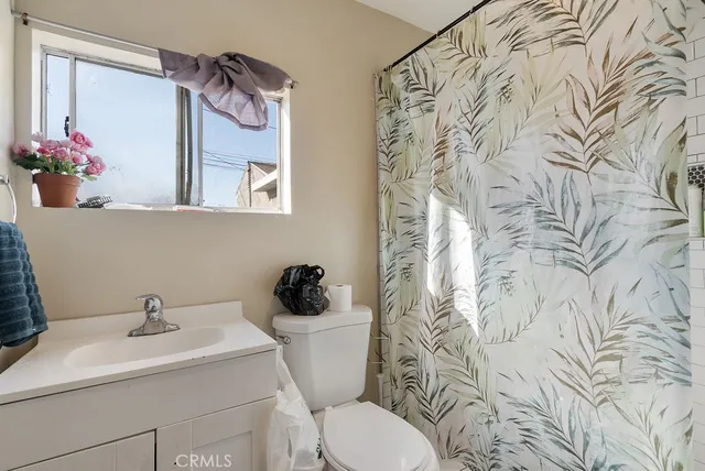 a bathroom with a sink and mirror with toilet