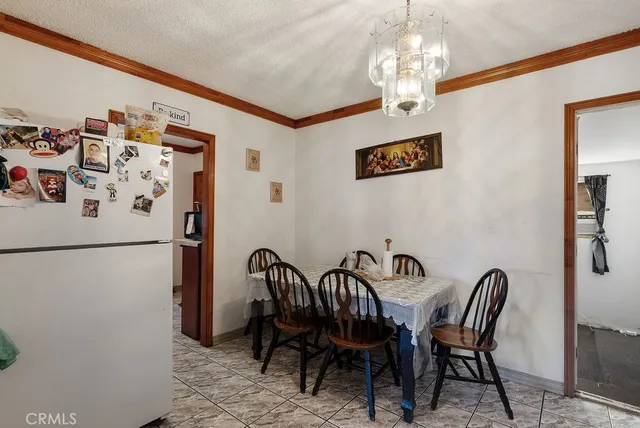a view of a dining room with furniture and chandelier