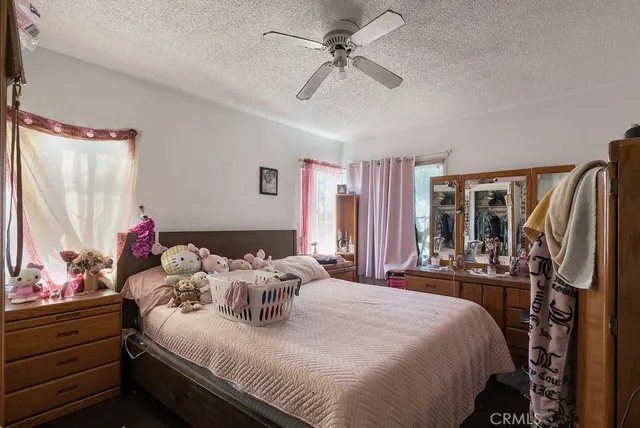 a bedroom with bed and a window