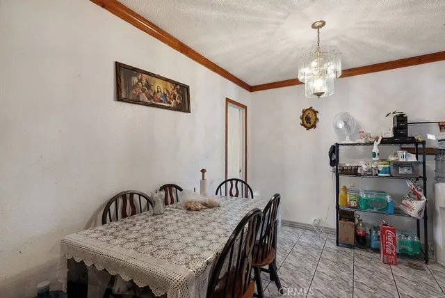 a view of a dining room with furniture and chandelier
