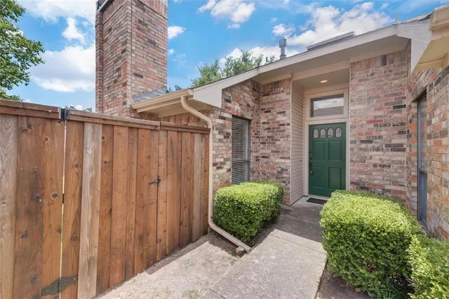 a view of a house with potted plants
