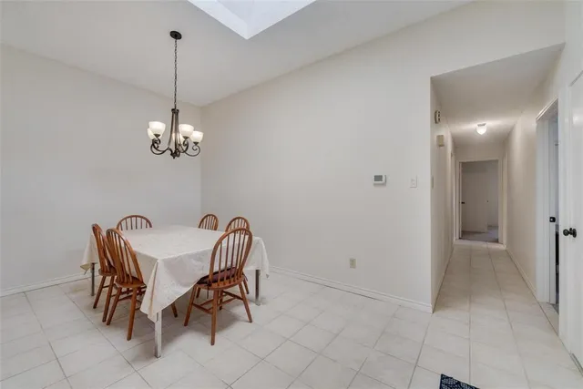 a view of a dining room with furniture and chandelier