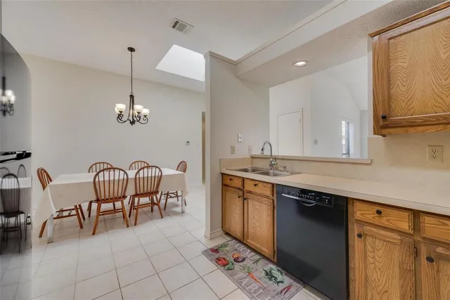 a view of kitchen with granite countertop dining table chairs and sink