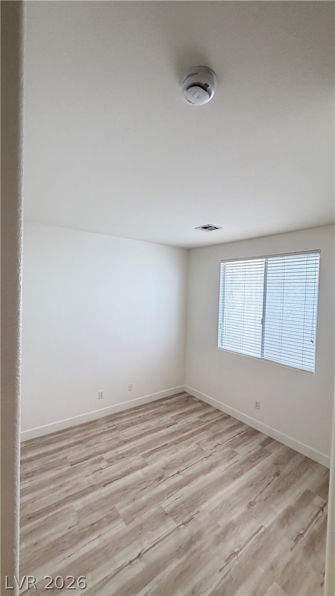 Gleaming wood-look floors complement the clean lines and neutral walls of this versatile space.