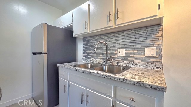 1803 West Sumac Lane, Unit 5 Anaheim, CA 92804 - Photo 6 of 18 a kitchen with a sink and cabinets