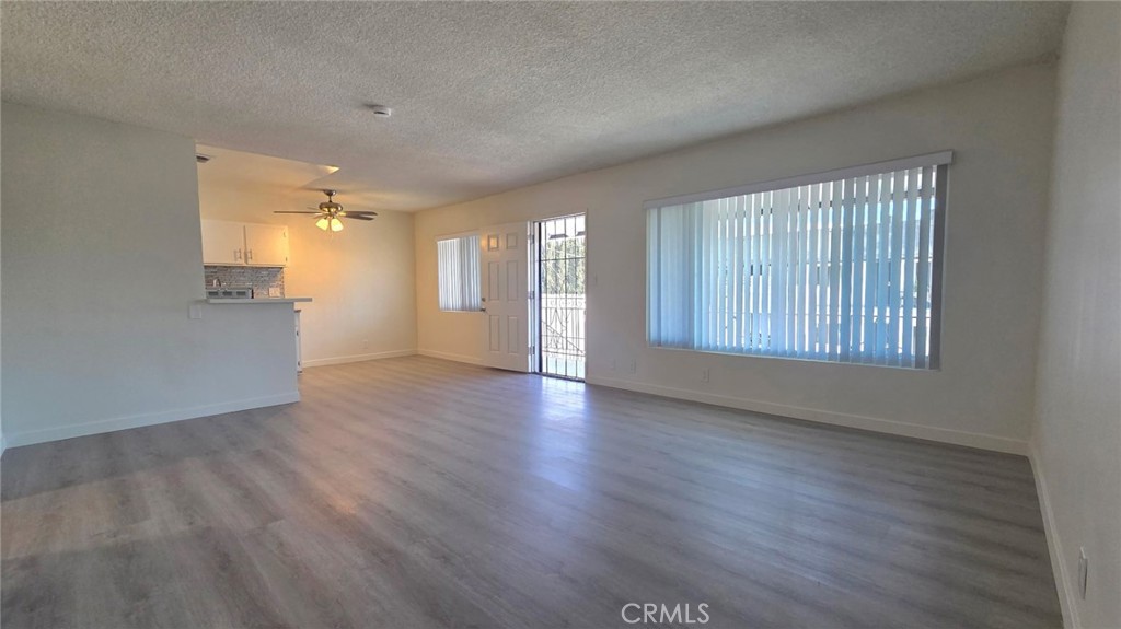 1803 West Sumac Lane, Unit 5 Anaheim, CA 92804 - Photo 9 of 18 a view of an empty room with window and wooden floor