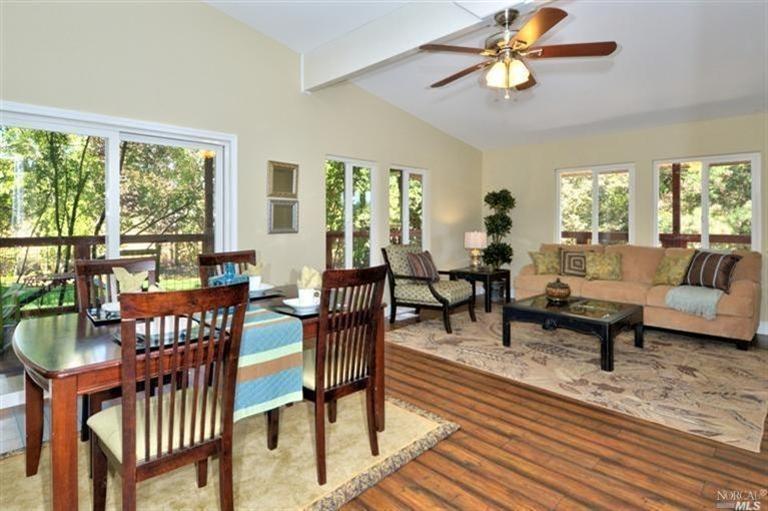 2320 Silk Road Windsor, CA 95492 - Photo 1 of 1 a living room with furniture a rug and a floor to ceiling window