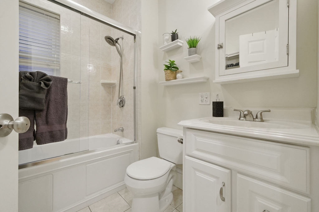 12 I Street, Unit 3 Boston, MA 02127 - Photo 12 of 19 a bathroom with a sink a toilet and shower