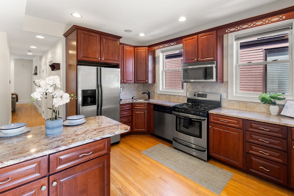 12 I Street, Unit 3 Boston, MA 02127 - Photo 4 of 19 a kitchen with stainless steel appliances granite countertop a sink stove and refrigerator