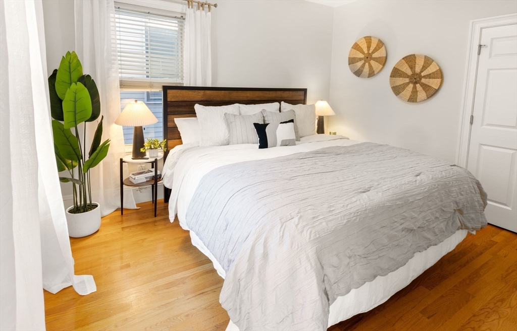 12 I Street, Unit 3 Boston, MA 02127 - Photo 6 of 19 a bed sitting in a bedroom next to a window