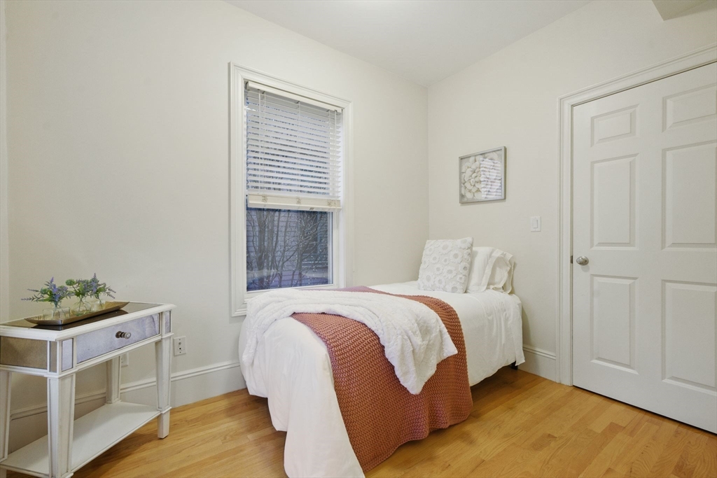 12 I Street, Unit 3 Boston, MA 02127 - Photo 8 of 19 a bed room with a bed and a window