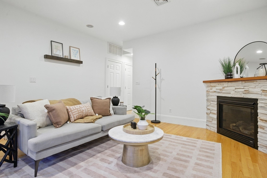 12 I Street, Unit 3 Boston, MA 02127 - Photo 9 of 19 a living room with furniture and a fireplace