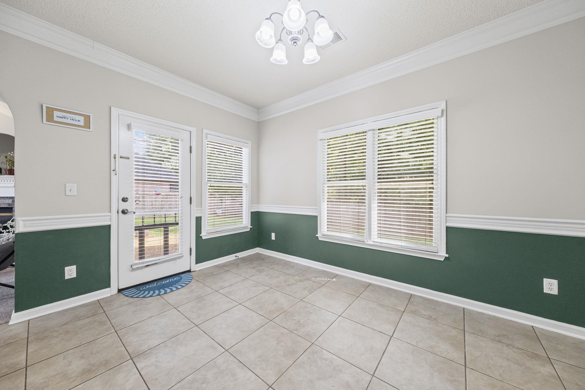 10467 Juneau Way Collierville, TN 38017 - Photo 14 of 34 a view of an empty room with a window and a kitchen
