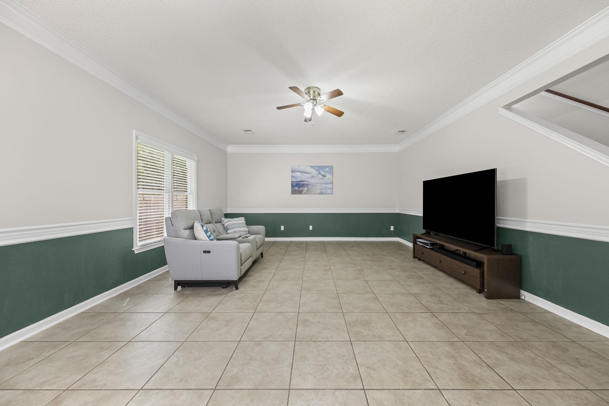 10467 Juneau Way Collierville, TN 38017 - Photo 15 of 34 a living room with furniture and a flat screen tv