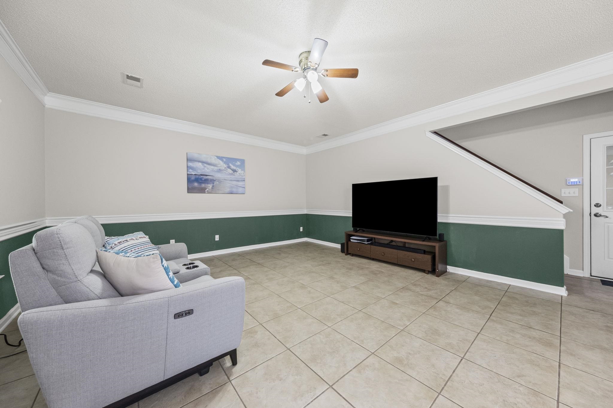 10467 Juneau Way Collierville, TN 38017 - Photo 16 of 34 a living room with furniture and a flat screen tv