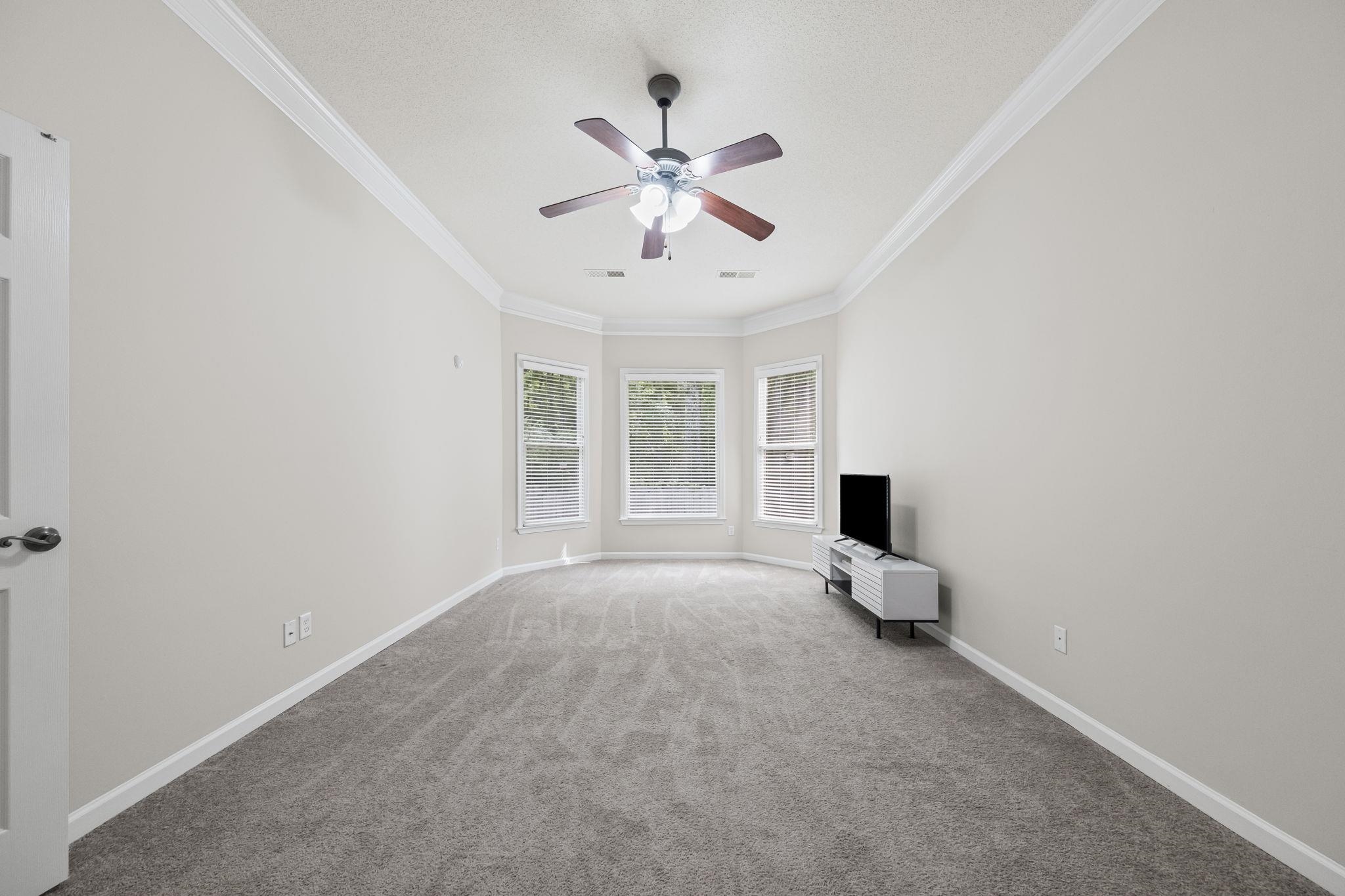 10467 Juneau Way Collierville, TN 38017 - Photo 18 of 34 a view of n empty room with window and a ceiling fan