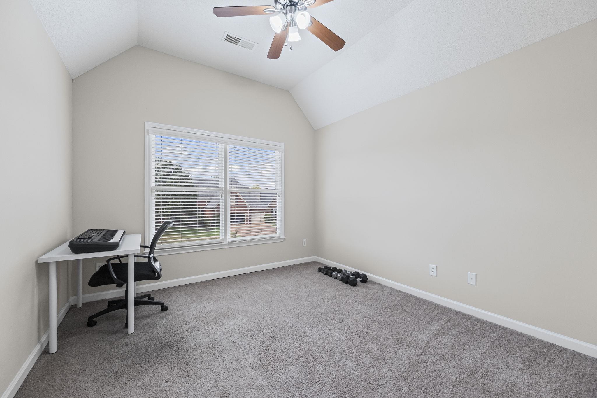 10467 Juneau Way Collierville, TN 38017 - Photo 30 of 34 a room with gym equipment and a window