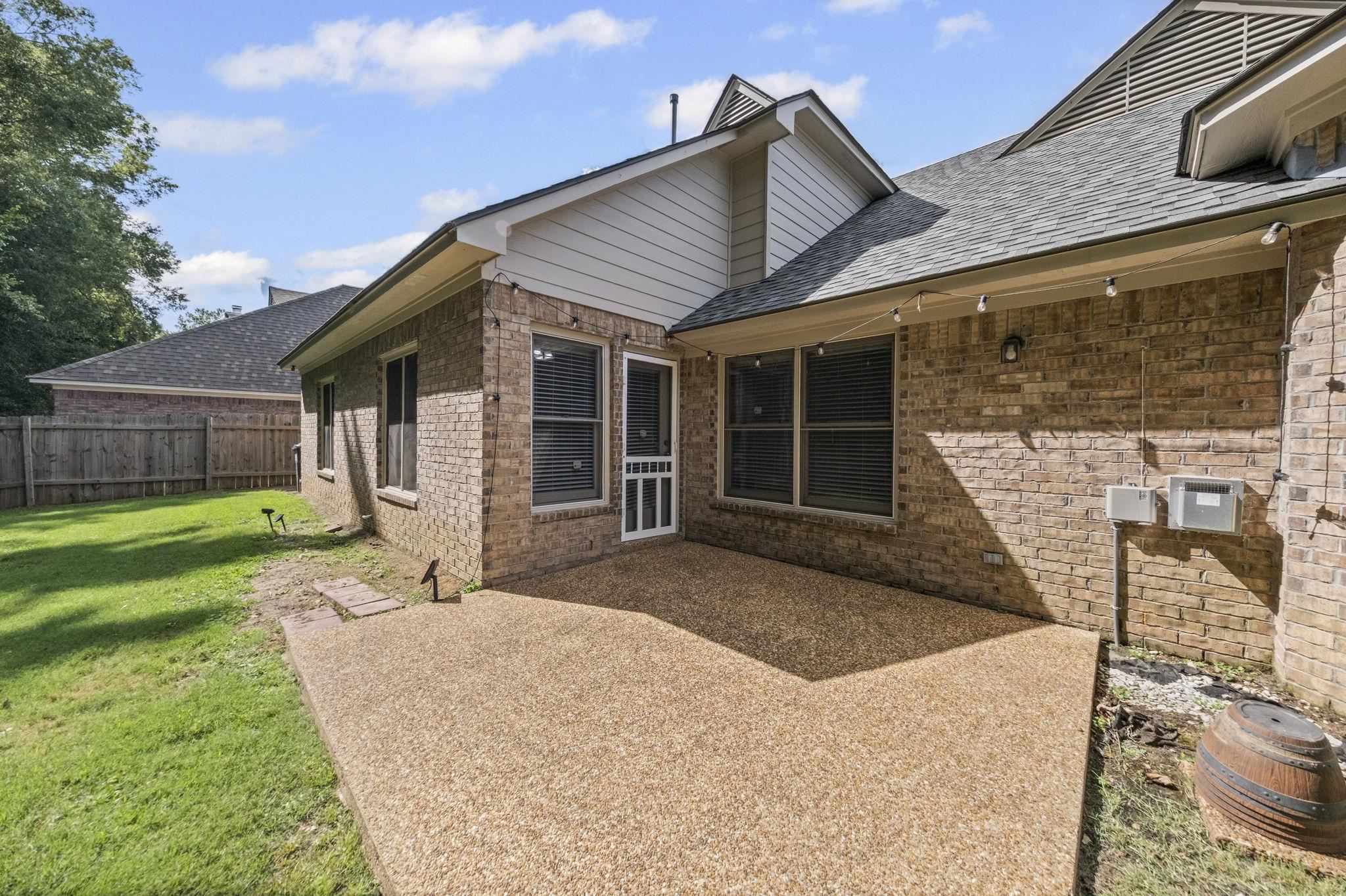 10467 Juneau Way Collierville, TN 38017 - Photo 34 of 34 a front view of a house with a yard and garage