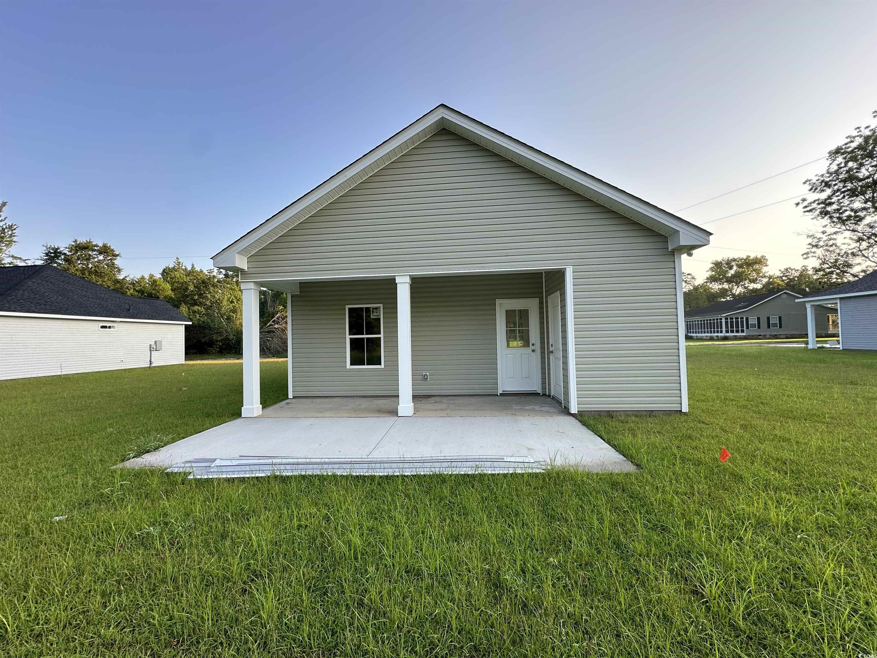 3474 Alton Road Loris, SC 29569 - Photo 16 of 16 View of home's exterior featuring a lawn and a pat